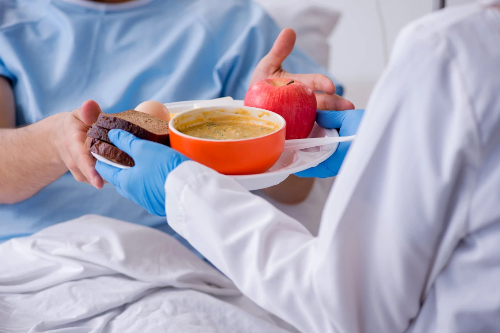 nurse handing over meal